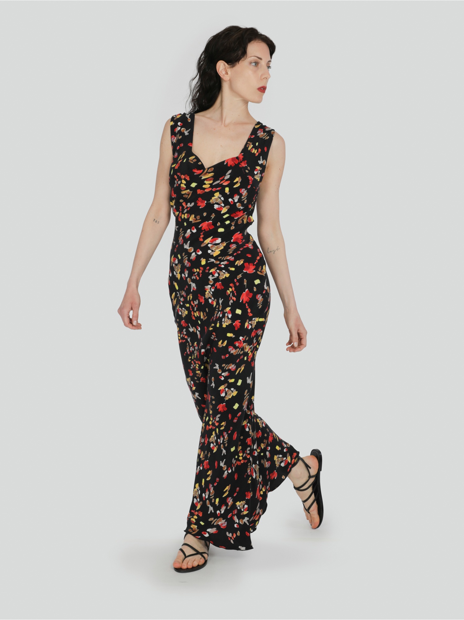 Woman long black soft dress in floral pattern without sleeves with square neckline and ties at the waist. Black, red and yellow color. 100% cupro, made in Italy. For sale online!