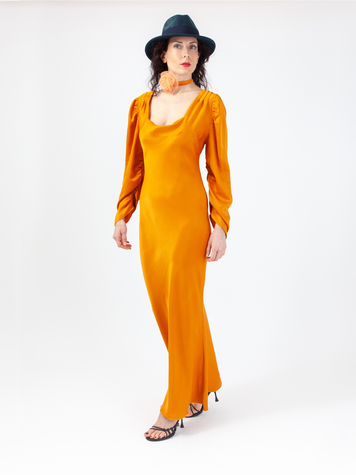 Soft orange satin woman dress, orange long dress, with gathered long sleeves and square neckline, laces at the waist and back out. Orange colour. 100% viscose, made in Italy. Buy online!